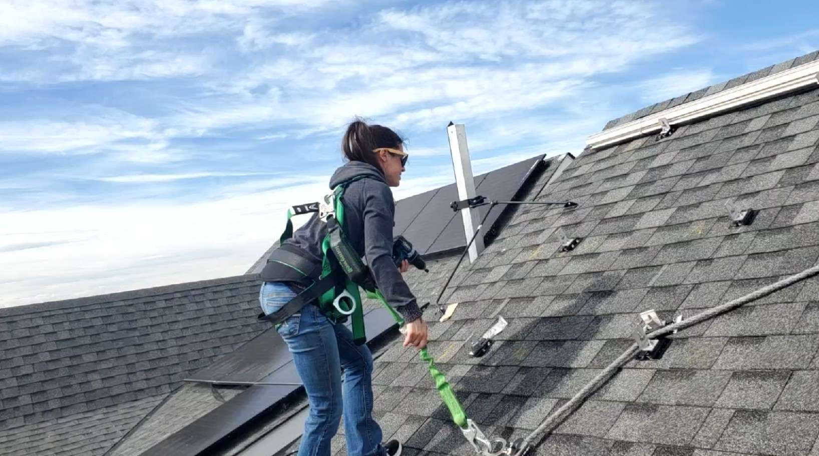 Solar installation crew on Calgary rooftop with safety harness