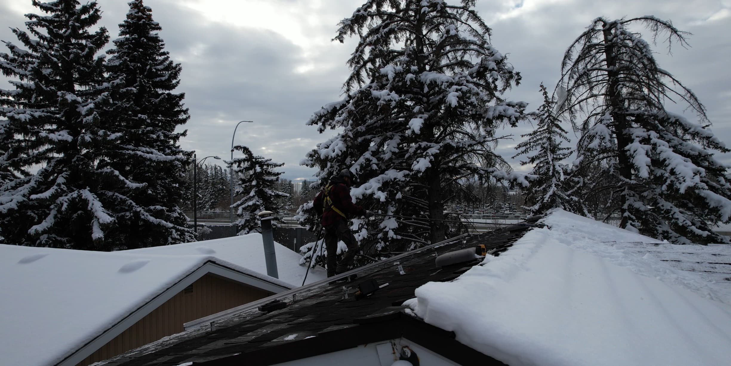Solar panel installation on snowy roof in Calgary winter